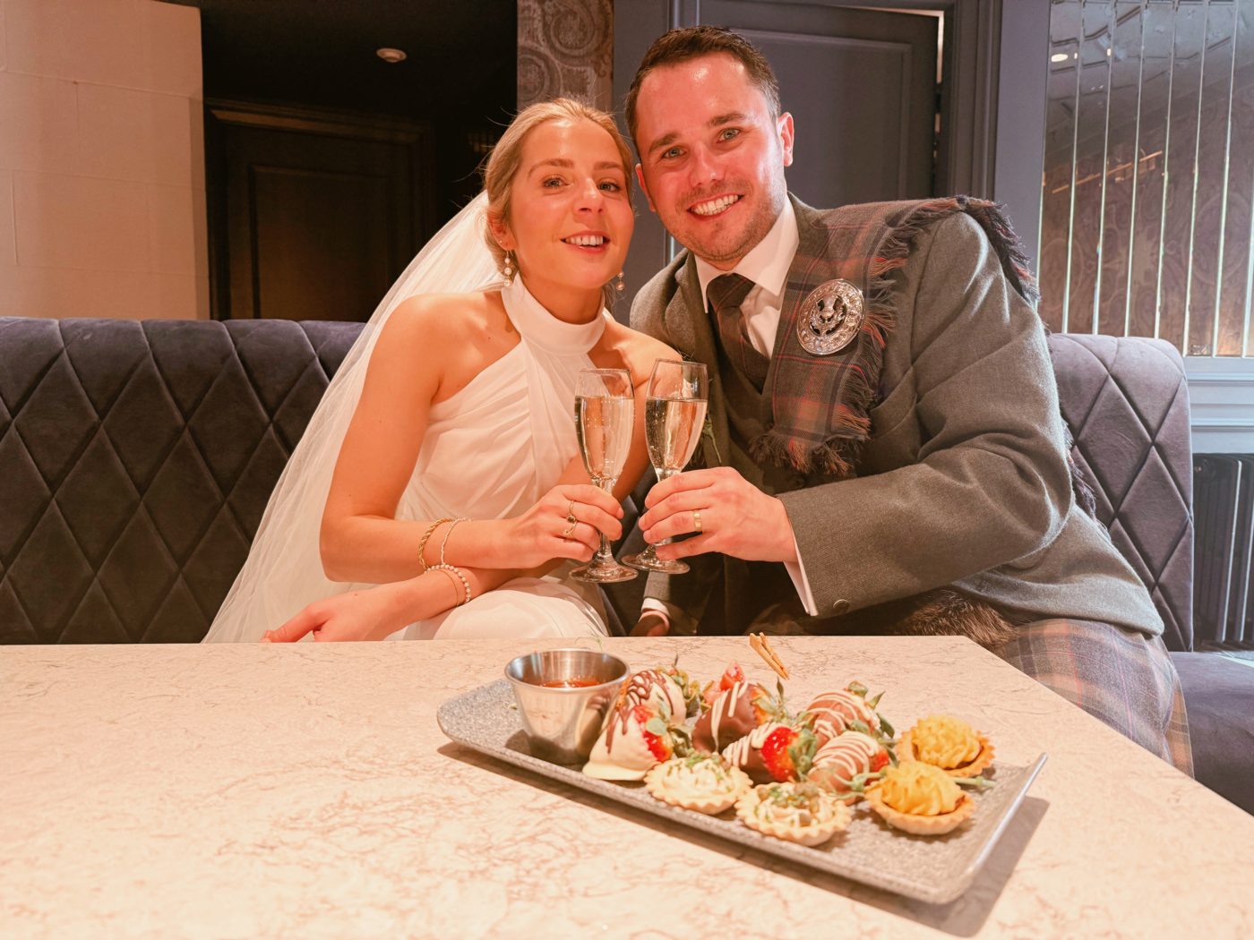 Nicole and Andy toasting with champagne after their wedding at the Brig o' Doon House Hotel, Alloway