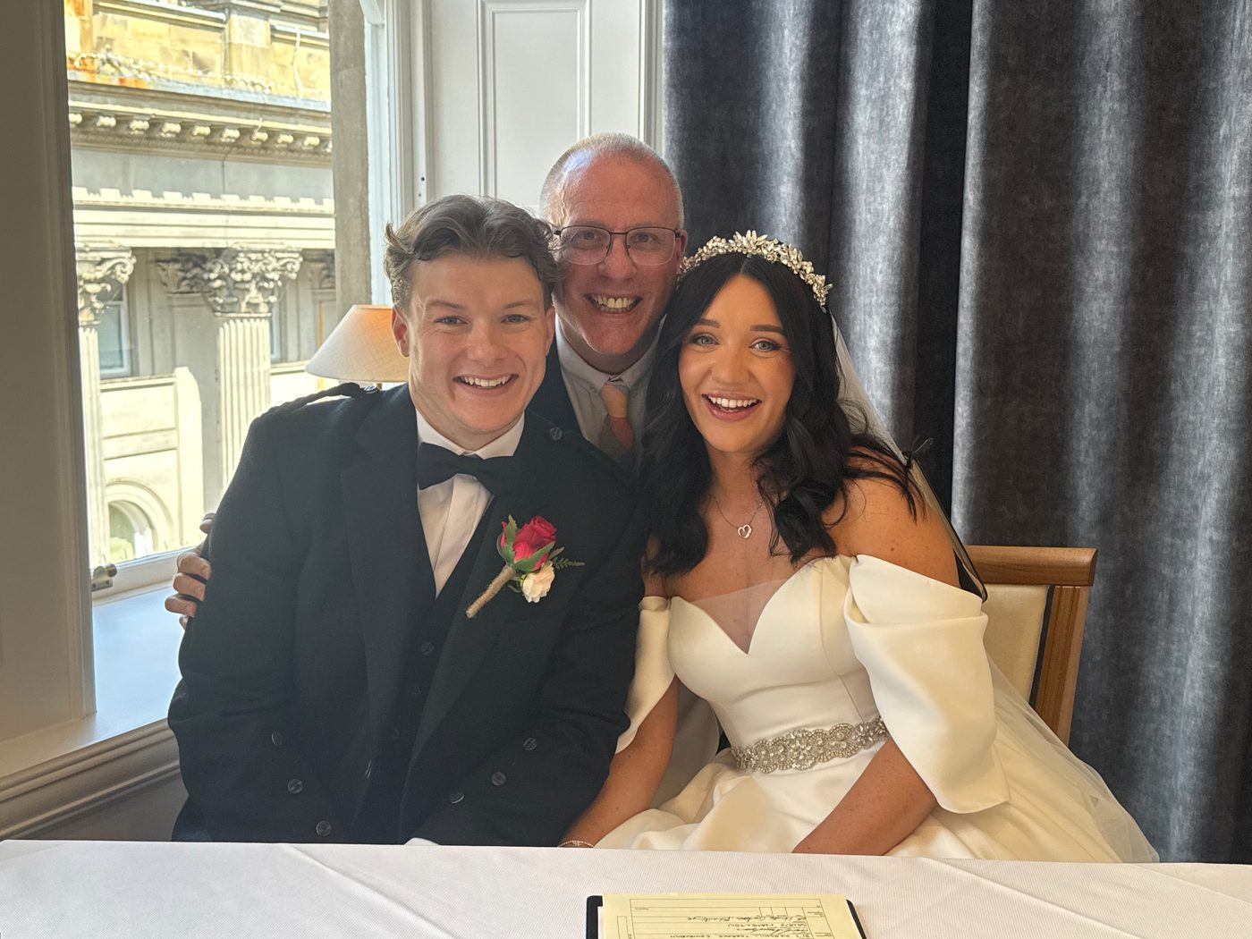 John Paul with a beaming couple after a city ceremony