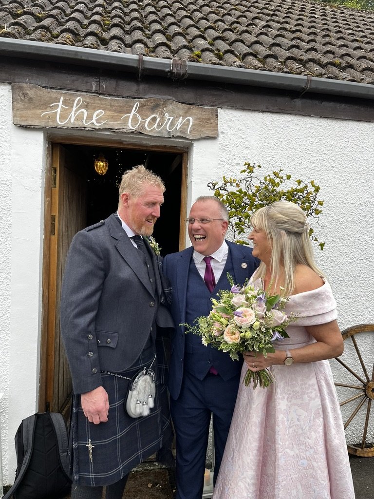 Christine and Stewart with John Paul outside the barn at Fruin Farm