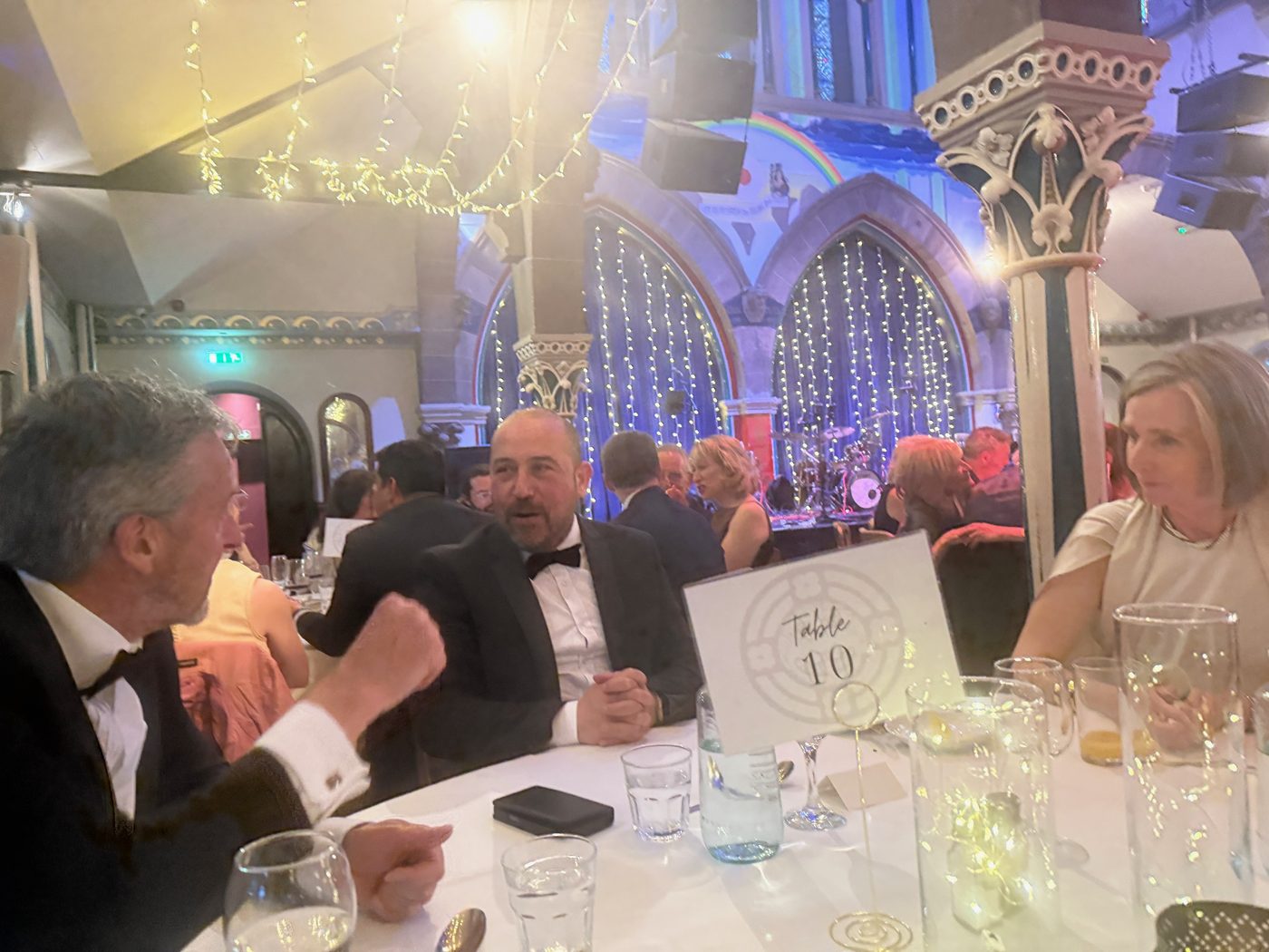An evening wedding under the arches of a converted church